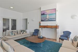 a living room with a couch and a fireplace at Ventaou in Sainte-Maxime