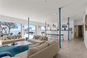 a living room with couches and a table at Ventaou in Sainte-Maxime