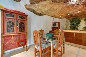 a kitchen with a table and chairs and a cabinet at Palacio Taro Chimida in Teguise