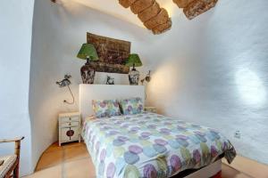 a bedroom with a bed in a white room at Palacio Taro Chimida in Teguise +20 photos