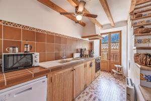 a kitchen with a sink and a microwave at Casa Antonia in Sóller
