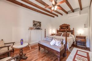 a bedroom with a bed and a table and a couch at Casa Antonia in Sóller