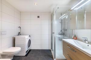 a bathroom with a washing machine and a washer at Apartments Winder 2 in Lustenau