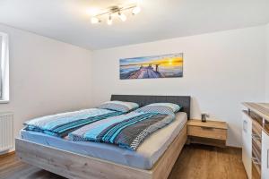 a bedroom with a bed with blue pillows at Apartments Winder 2 in Lustenau