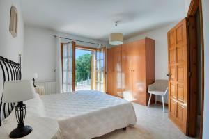 a bedroom with a white bed and a sliding glass door at Villa Speranza by Easy Brava in Calonge +22 photos