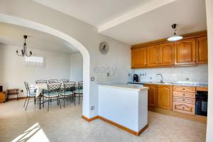 a kitchen with an archway and a table with chairs at Villa Speranza by Easy Brava in Calonge
