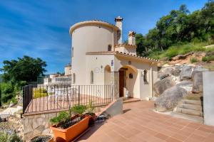 a small white house with a tower on a hill at Villa Speranza by Easy Brava in Calonge