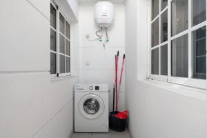 a laundry room with a washing machine and a window at Kays studio in Puerto del Carmen