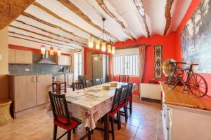 a kitchen and dining room with a table and a bike on the wall at La Casica del Sol in Requena
