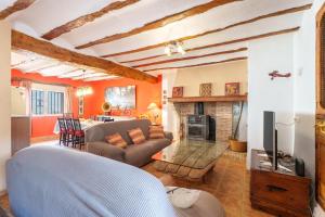 a living room with a couch and a fireplace at La Casica del Sol in Requena