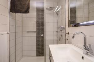 a white bathroom with a shower and a sink at Ferienwohnung Eberle in Eriskirch +16 photos