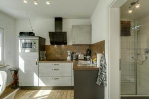 a kitchen with a sink and a refrigerator at Ferienwohnung Eberle in Eriskirch