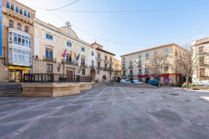 an empty street in a city with buildings at Apartamentos El Compromiso in Caspe