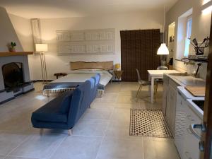 a bedroom with a bed and a kitchen with a table at Gipsy Rose in Sarzana
