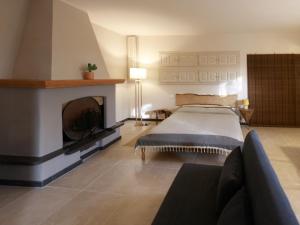 a bedroom with a bed and a fireplace at Gipsy Rose in Sarzana