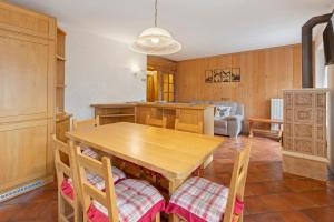 a kitchen with a wooden table and chairs at Fior di montagna in Bormio