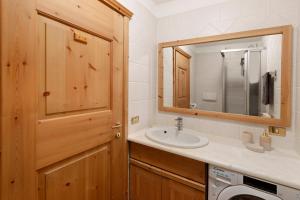a bathroom with a sink and a washing machine at Fior di montagna in Bormio +25 photos