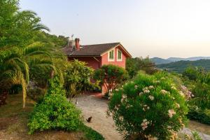 a house on a hill with trees and bushes at Gipsy Rose in Sarzana