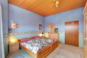a bedroom with a bed and a wooden ceiling at Haus Domblick in Gückingen +35 photos