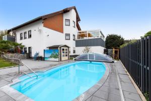 a swimming pool in front of a house at Haus Domblick in Gückingen