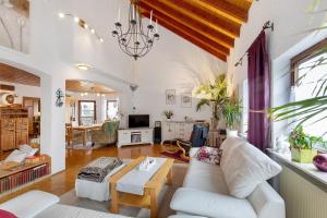 a living room with a white couch and a table at Haus Domblick in Gückingen