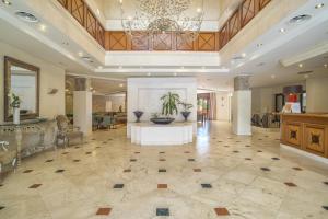 a large lobby with a table with two vases on it at Beach front apartment Mar Azul in Estepona +21 photos