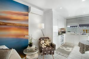 a living room with a teddy bear sitting on a chair at Estrella Del Mar Amazing Loft Casa in Mogán