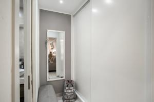 a hallway with a mirror and a chair in a room at Estrella Del Mar Amazing Loft Casa in Mogán +23 photos