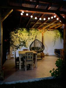 a patio with a table and chairs and a swing at Golden hour tiny house in Arusha