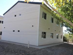 a white building with windows on the side of it at El Portal Los Álamos in Rincon de los Sauces