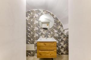 a bathroom with a sink and a mirror at Casa Don Michele in Specchia +13 photos