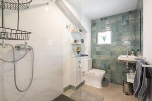 a bathroom with a shower and a toilet and a sink at La Fabriqueta Apartament in Ríudecañas +26 photos