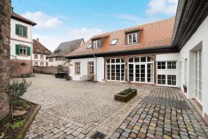 a courtyard of a house with a brick driveway at Historisches Forstamt in Gernsbach