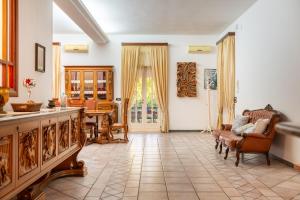 a living room with a couch and a table at Villa Dany with pool in Villa Castelli