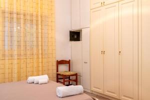 a bedroom with a bed and a chair and a cabinet at Villa Dany with pool in Villa Castelli +35 photos