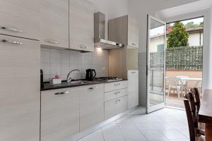 a kitchen with stainless steel appliances and a dining room at Giada Apartment in Calenzano