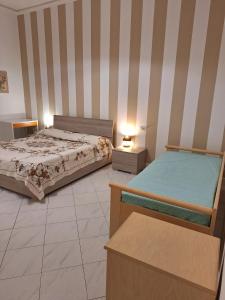 a bedroom with two beds and two night stands at Giada Apartment in Calenzano