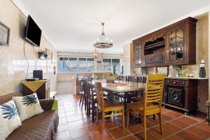 a kitchen and dining room with a table and chairs at Casa Campo e Mar in Encarnação