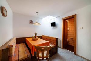a dining room with a table and a chair at Rieglhof Apartment Kükennest in Curon Venosta
