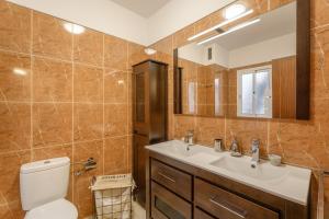 a bathroom with a toilet and a sink and a mirror at Las Cucharitas in La Guancha +22 photos