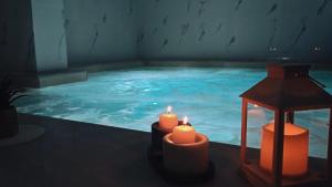 a large swimming pool with candles in front of it at Maribel Spa Hotel in Köprilova