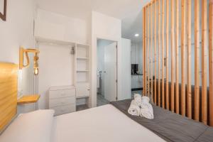 a bedroom with a bed with two pairs of shoes at Casa Abuela Maria in Jerez