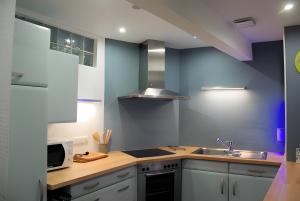 a kitchen with a sink and a counter top at Cour Du Weinhof à Colmar in Colmar +28 photos