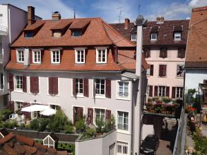 a large white building with a red roof at Cour Du Weinhof à Colmar in Colmar