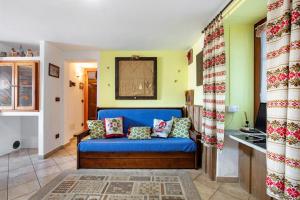 a living room with a blue couch in a room at Maison Cerise Pila in Gressan