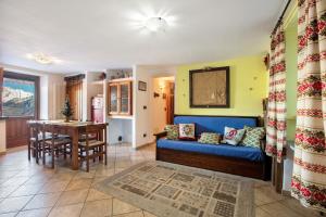 a living room with a blue couch and a table at Maison Cerise Pila in Gressan