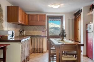 a kitchen with a table with a christmas tree on it at Maison Cerise Pila in Gressan +17 photos