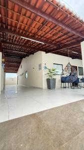 a room with chairs and a swing in a building at Casa em tibau in Tibau