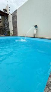 a water fountain in a swimming pool at Casa em tibau in Tibau +25 photos