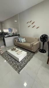 a living room with a couch and a table at Casa em tibau in Tibau